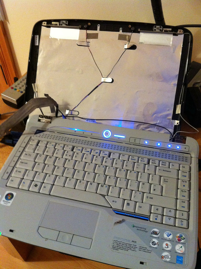 A laptop being repaired on a workbench (extended warranty) (electronics extended warranty)