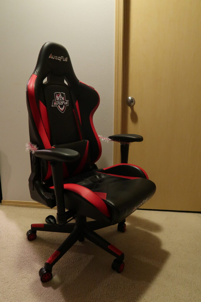 A gaming chair positioned at a desk setup (gaming chair vs office chair)