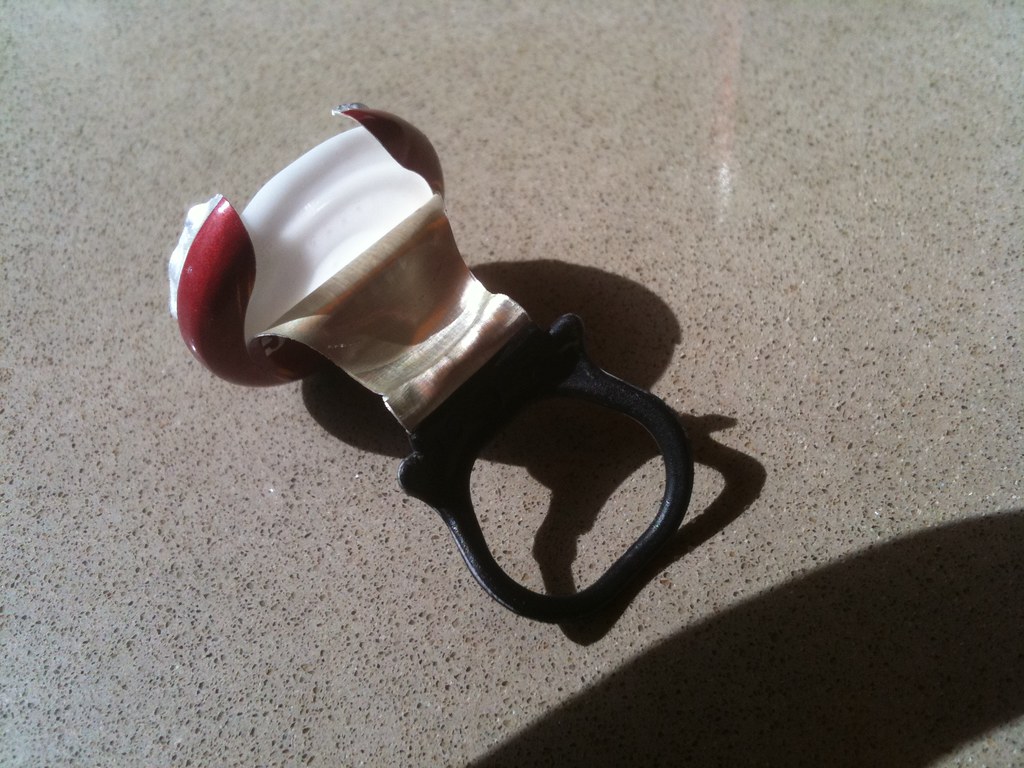 A smart ring wearable device shown close up on a hand
