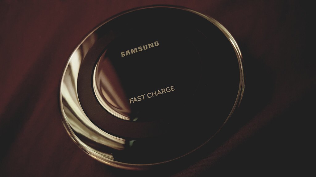 A smartphone charging wirelessly on a charging pad (qi2) (qi2 wireless charging)