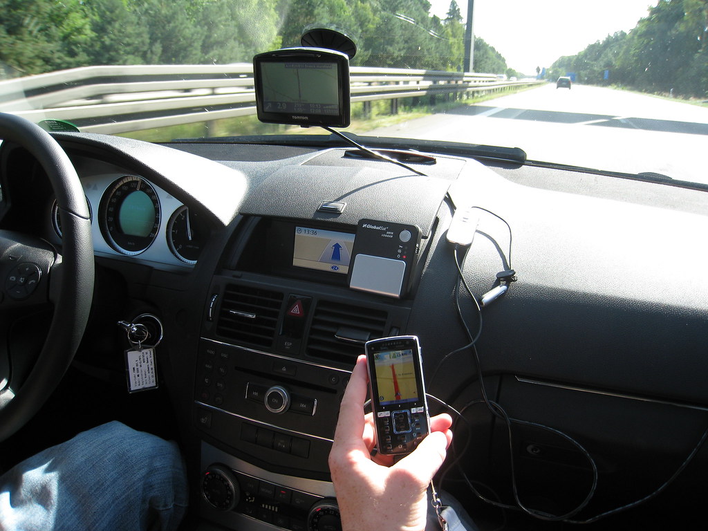 An elderly person wearing a GPS tracking pendant device (gps tracker)