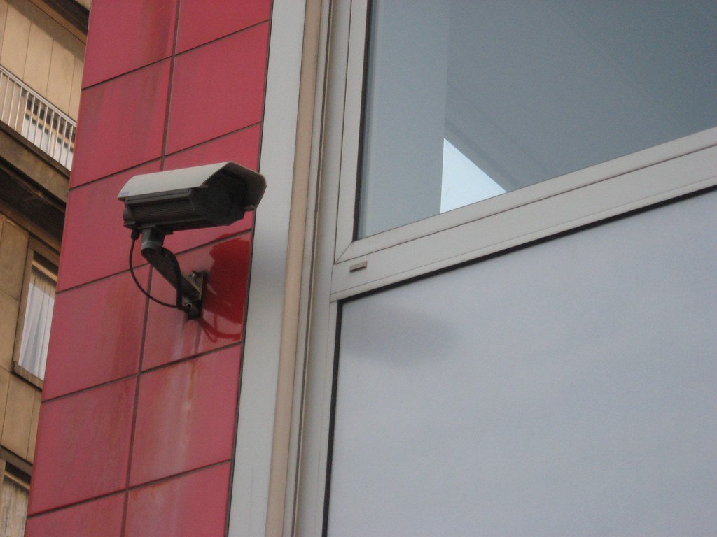 A security camera mounted on a building wall (self-monitoring)